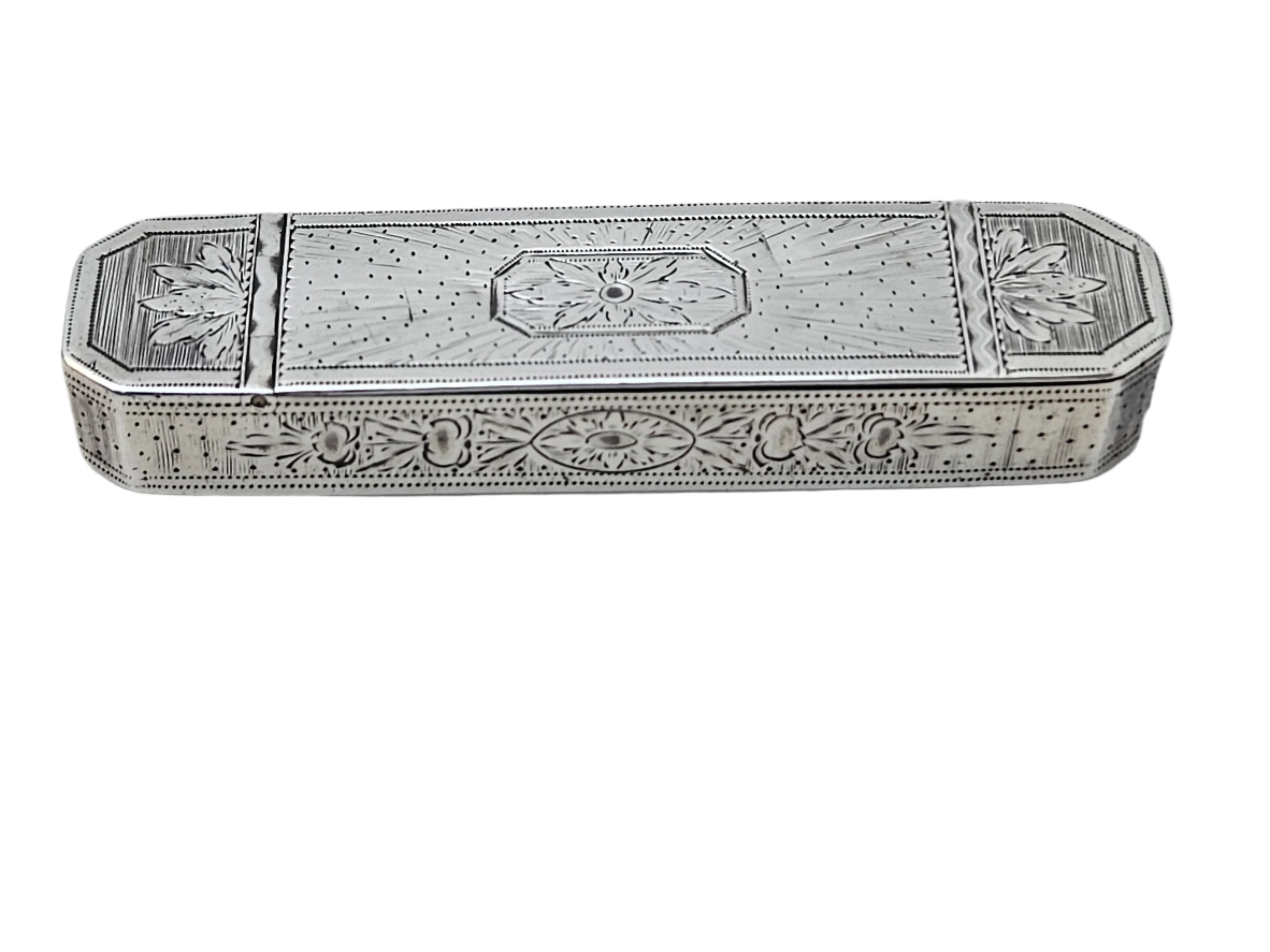 A late 18th century antique English tooth pick box in sterling silver by Samuel Pemberton, adorned with intricate engraved patterns of floral and geometric designs, from SEVENTH PLATEAU, placed on a white marble surface.