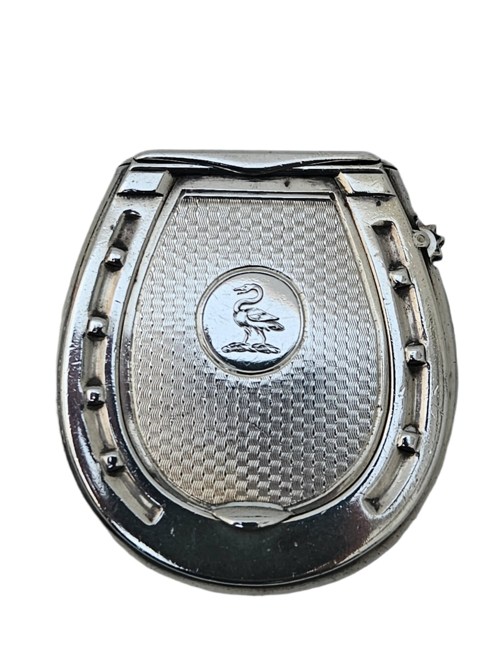 Presented against a light gray background, the SEVENTH PLATEAU's STERLING SILVER 19TH CENTURY ANTIQUE FRENCH SNUFF BOX & VESTA MATCH CASE showcases a textured, horseshoe-shaped design with an engraved pelican adorning its center.