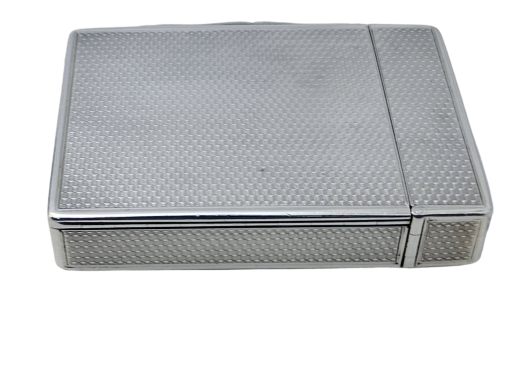 A sleek, square STERLING SILVER 19TH CENTURY ANTIQUE ENGLISH SNUFF BOX & CALLING CARD CASE from SEVENTH PLATEAU, featuring a textured pattern on its surface, resting on a flat, light-toned background. The case has a hinged lid and boasts a compact design.
